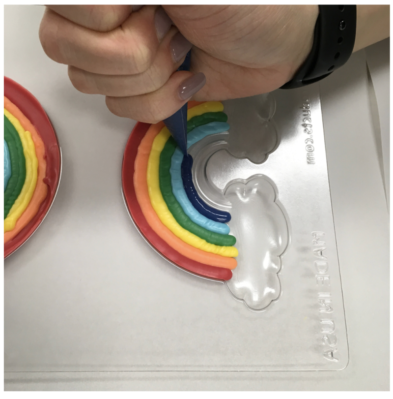 Piping a rainbow chocolate mould